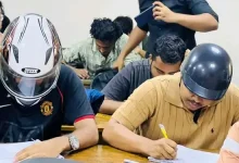 হেলমেট পরে ক্লাসে দুই শিক্ষার্থী, কেন জানেন?